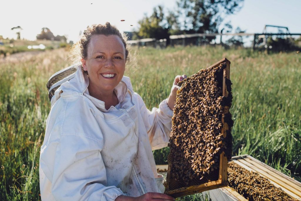 Claire Moore, 2019 AgriFutures Rural Women's Award National Runner Up, with one of her bee hives