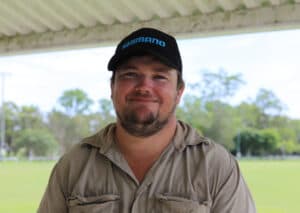 A close-up photo of Phil Brett at ginger field day in a paddock wearing a black cap. 