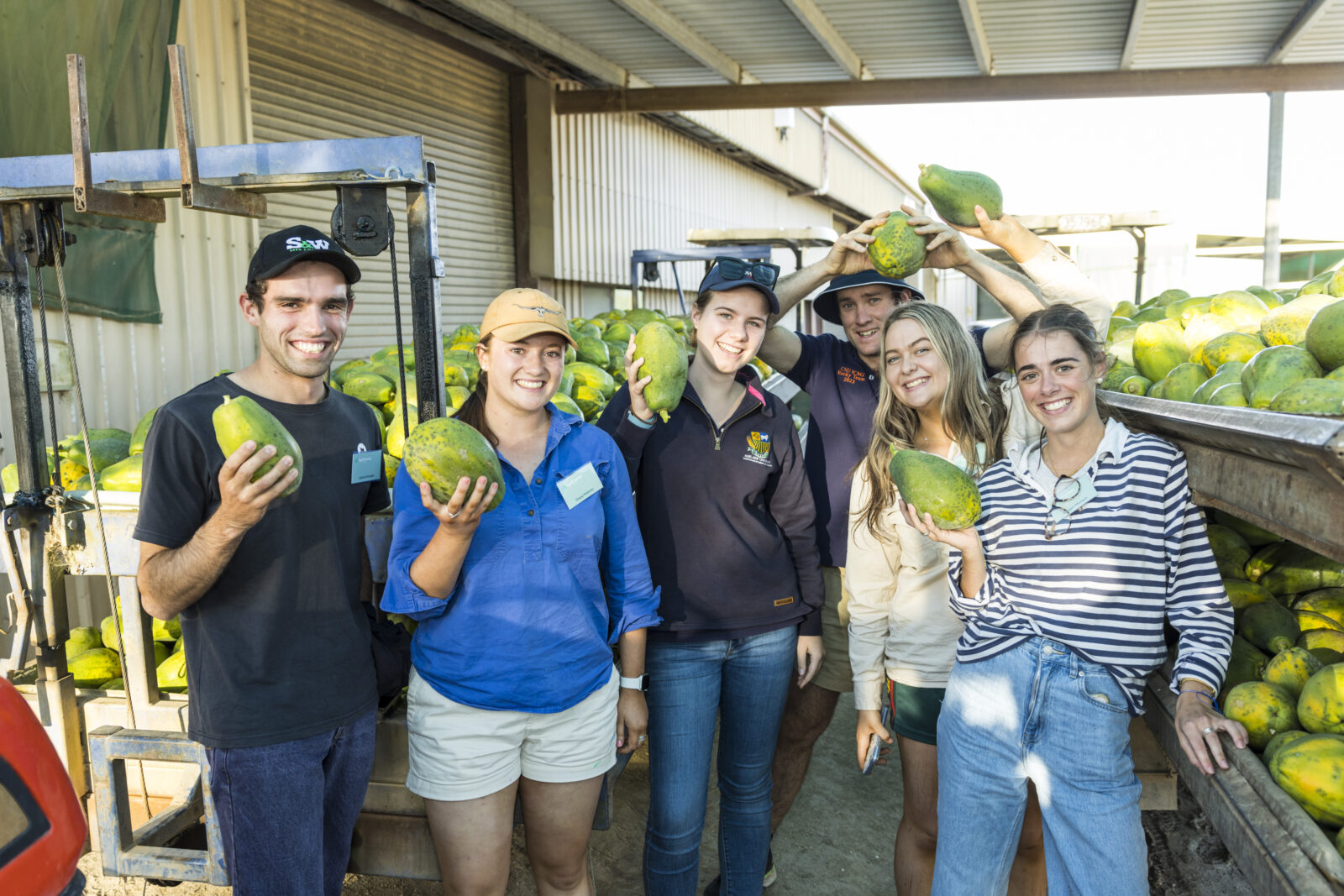 AgriFutures Horizon Scholars at SkyBury Plantation on the Atherton Tablelands, QLD, holding Papaya.