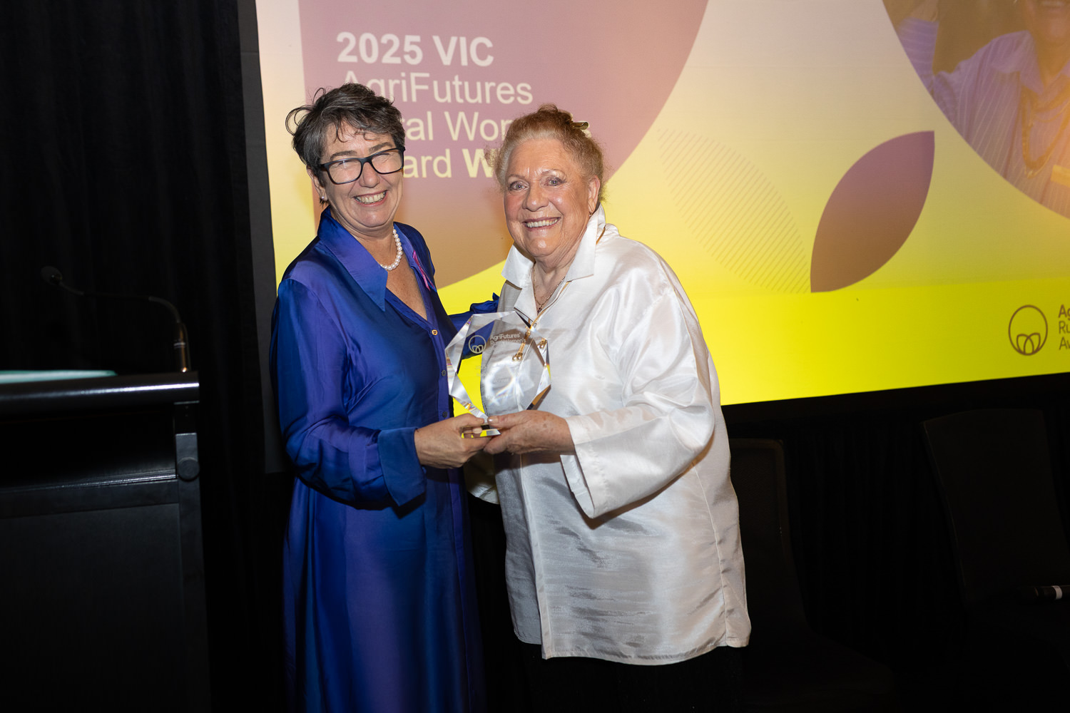 Dr Mary Cole accepting the 2025 VIC Rural Women's Award from Michaela Settle MP, Parliamentary Secretary for Regional Development and Agriculture, Victoria.