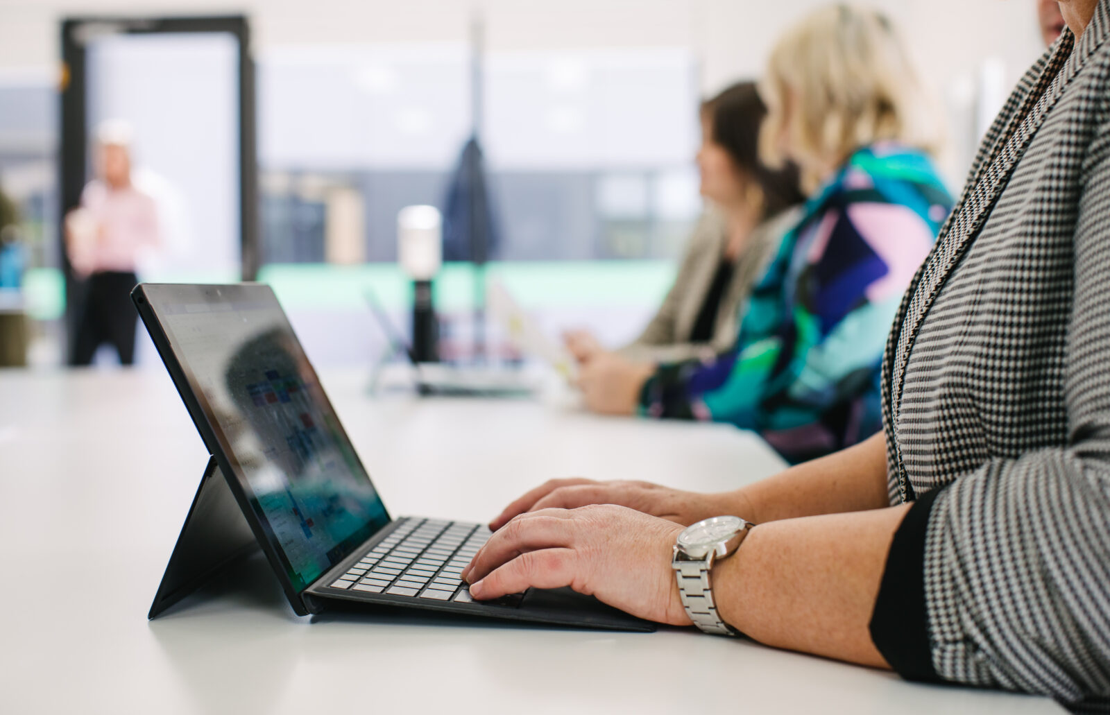 Arms at a laptop in an office