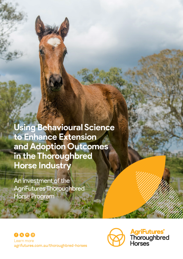 A young foal stands in a grassy field with mature horses and trees behind it. Text reads Using Behavioural Science to Enhance Extension and Adoption Outcomes in the Thoroughbred Horse Industry
